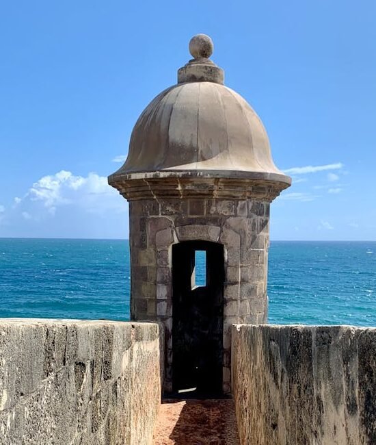 Historic Garita del Diablo at San Juan's coast with ocean view under a clear blue sky.
